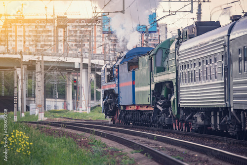 Retro steam train on city background. Moscow.