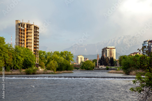 The Terek river with views of city dominants, against the background of Table Mountain. Vladikavkaz, North Ossetia, Russia photo