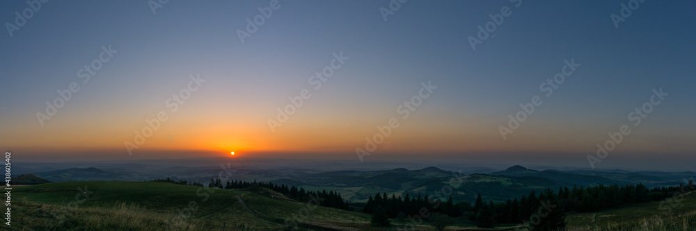 Panoramic view during sunset from Wasserkuppe, the highest point in Roehn Mountains under a clear sky, Germany