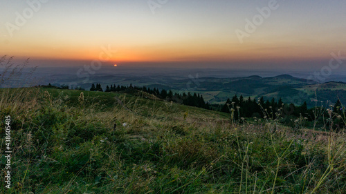 Sunset from Wasserkuppe  the highest point in Roehn Mountains with meadow in foreground under a clear sky  Germany