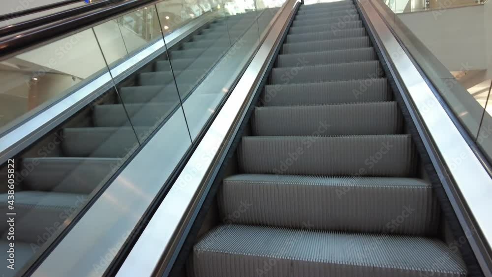 Moving up on modern empty escalator. Close-up modern escalator stairs Moving up on modern empty escalator. Close-up modern escalator stairs