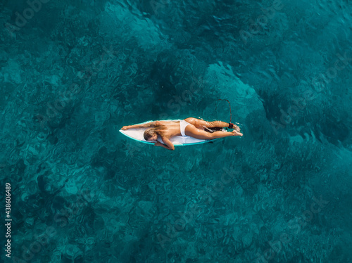 Photography Sexy surfer woman relaxing with surfboard in tropical ocean