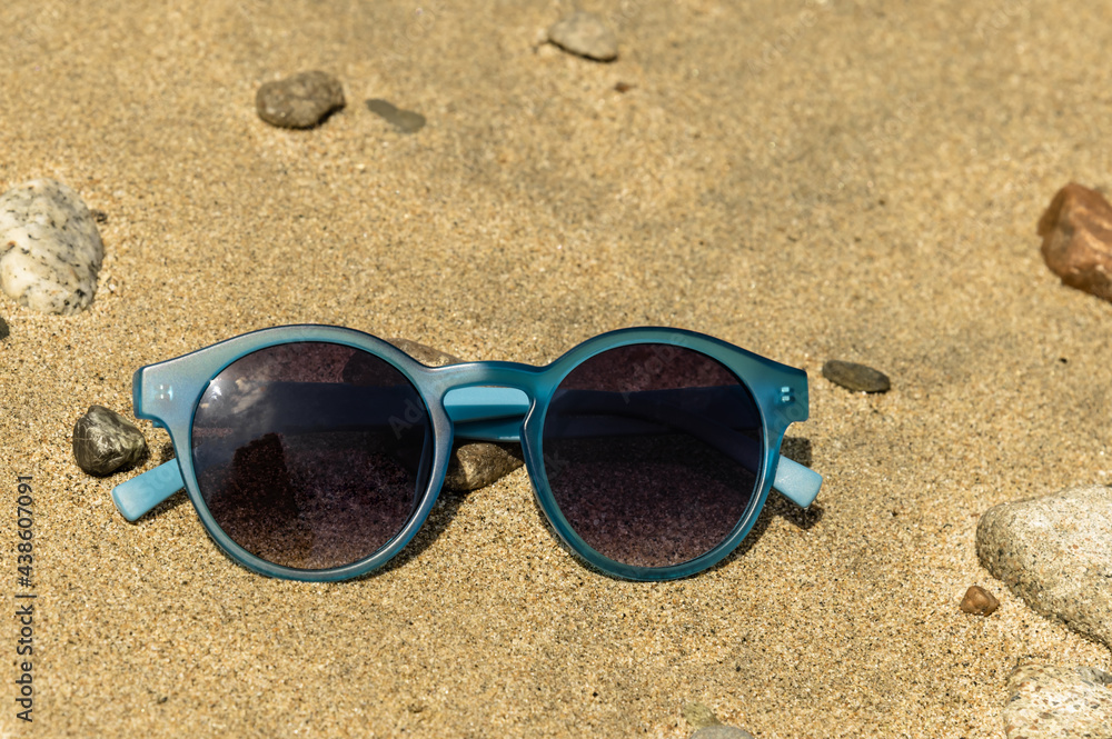 blue sunglasses on the beach