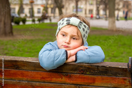 child sitting on a bench
