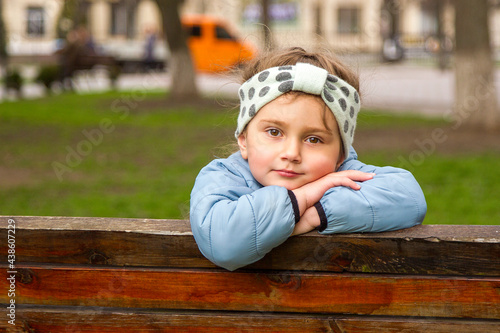 little child sitting on a bench