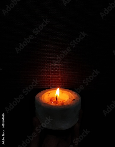 A glowing candle in the dark