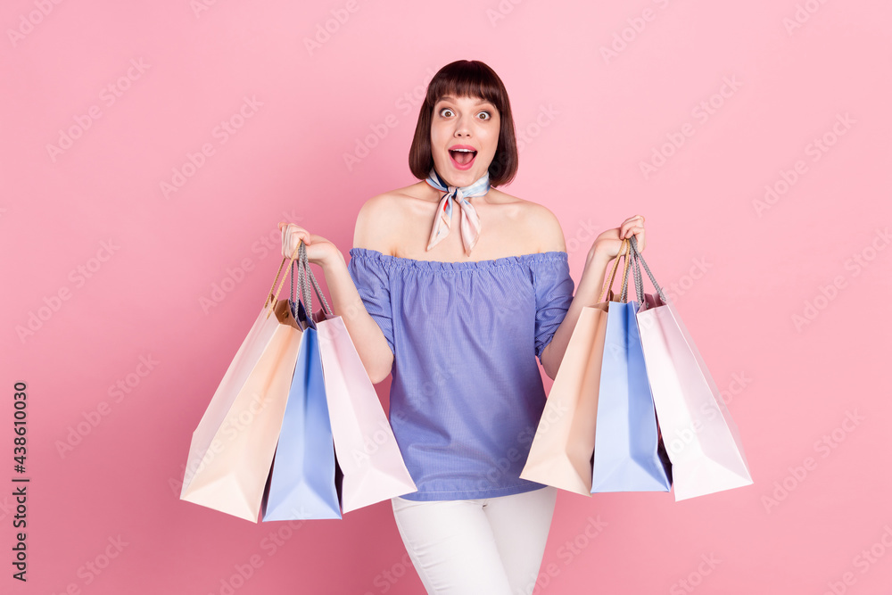 Photo portrait of woman amazed big discount in shopping mall isolated on pastel pink color background Photo portrait of woman amazed big discount in shopping mall isolated on pastel pink color background