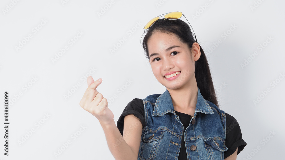 Asian Young woman gesture posing on white background. represent cheerful and confident. Showing gestures such as mini heart Okay Thumb up or point out. Happy amazed excited and surprised Jacket jeans. Asian Young woman gesture posing on white background. represent cheerful and confident. Showing gestures such as mini heart Okay Thumb up or point out. Happy amazed excited and surprised Jacket jeans.