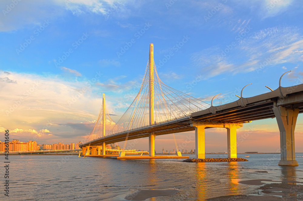 Cable-stayed bridge in the light of the setting sun across the Neva River on the Western Rapid Diameter highway in St. Petersburg, Russia