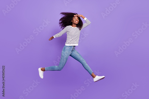 Full length body size view of pretty cheerful girl jumping running meet friend isolated over violet purple color background © deagreez