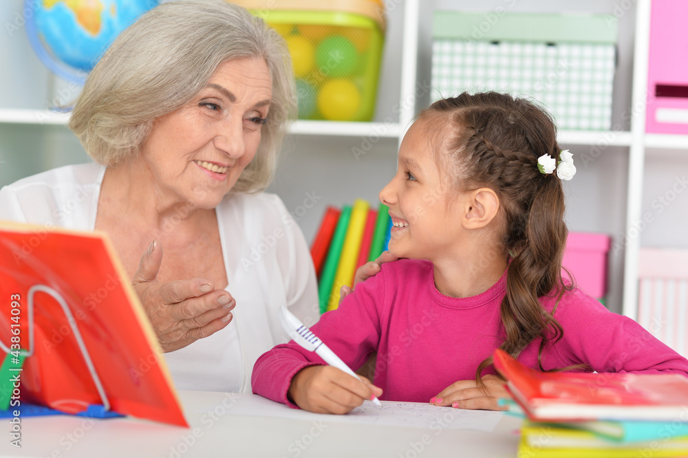 Cute little girl drawing with her grandmother Cute little girl drawing with her grandmother