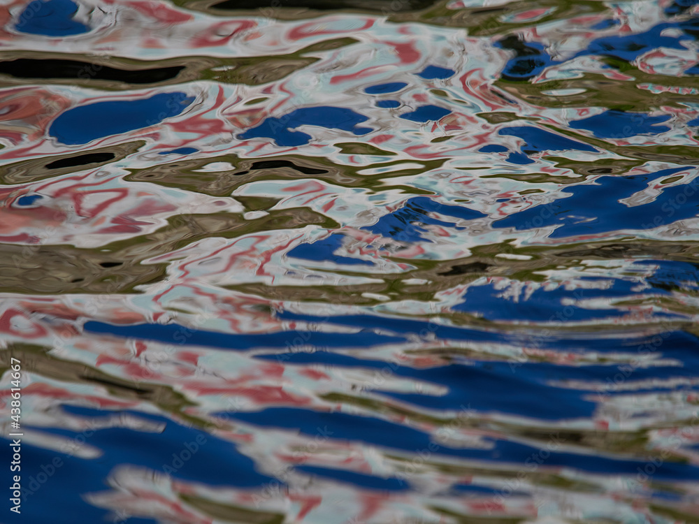 Streaks on the pond with green blooming water. Texture. Beautiful background.