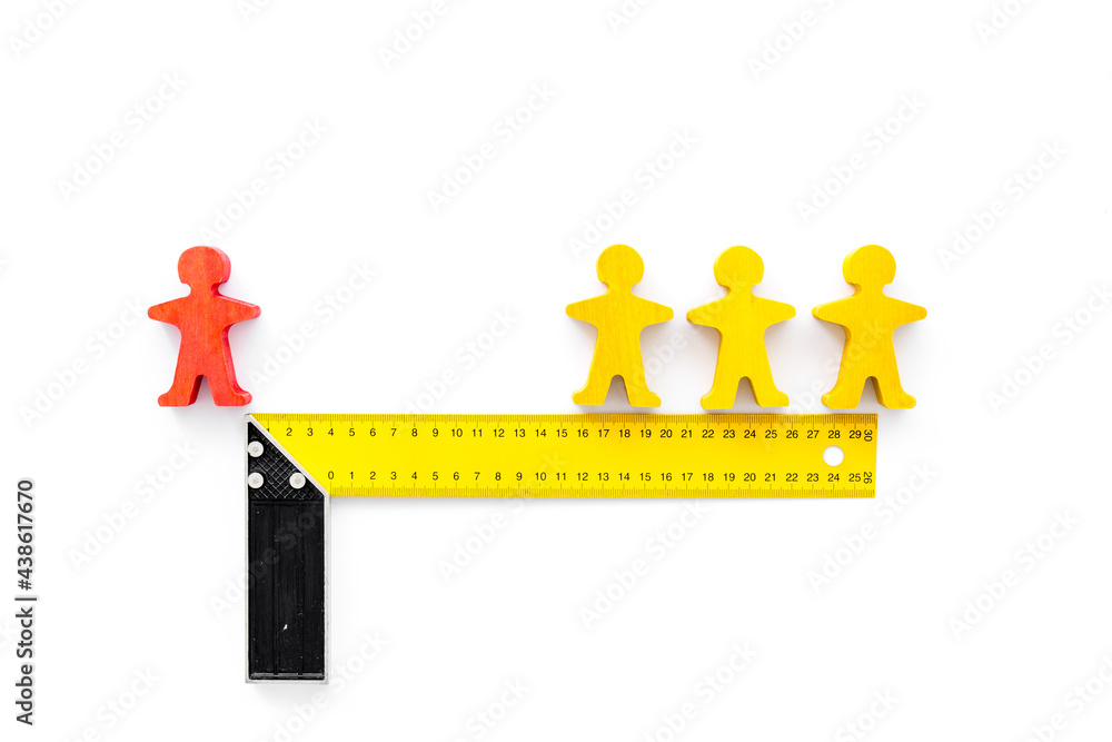 Keep social distance concept with two man figures and metal ruler Keep social distance concept with two man figures and metal ruler
