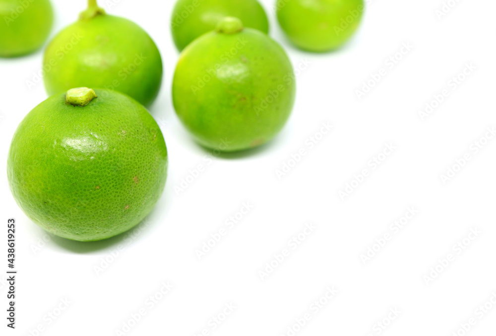 Closeup a Vivid Green Key Lime Fruit with Blurry Another Isolated on White Backdrop Closeup a Vivid Green Key Lime Fruit with Blurry Another Isolated on White Backdrop