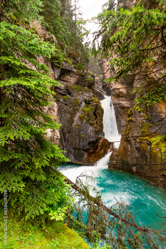 Hiking trail in the Rocky Mountains. Waterfall in the Johnston Canyon. Banff National Park, Alberta, Canada Hiking trail in the Rocky Mountains. Waterfall in the Johnston Canyon. Banff National Park, Alberta, Canada