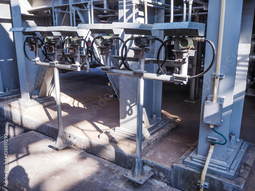 Temperature transmitter for measuring instrument close up in industry zone at power plant.