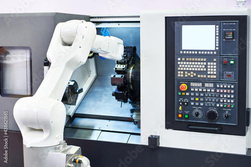 Robotic arm and cnc lathe machine photo