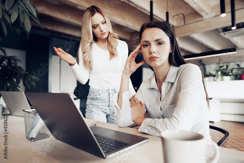 Young female boss scolding her female subordinate for bad work results