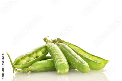 Several organic green pea pods, close-up, isolated on white.