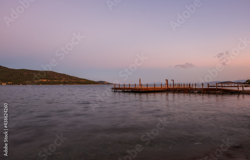 sunset over bay in Aegean sea. Torba  Bodrum  Turkey. October 2020. Long exposure picture with pier  jetty