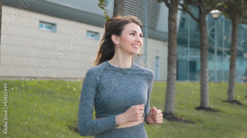 Free Download Portrait of young and fit woman running and jogging alone on the empty street in city center wearing protective. Concept of losing weight with exercise for health. Slow-motion shot. Sports - GFXLoad