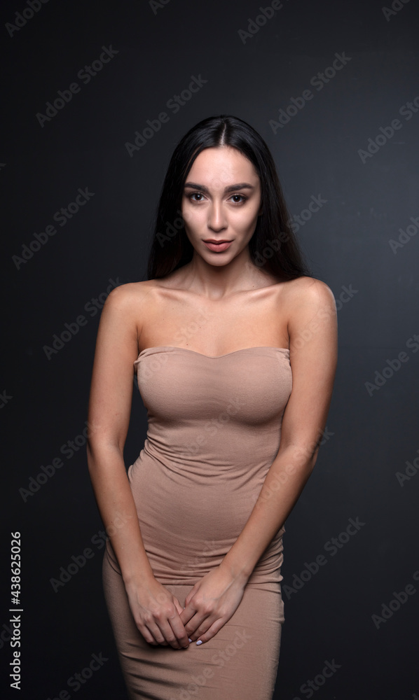 portrait of a young woman in the studio on a dark background portrait of a young woman in the studio on a dark background