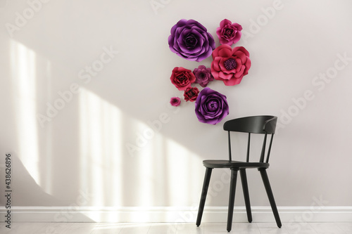 Stylish room interior with floral decor and black chair, space for text