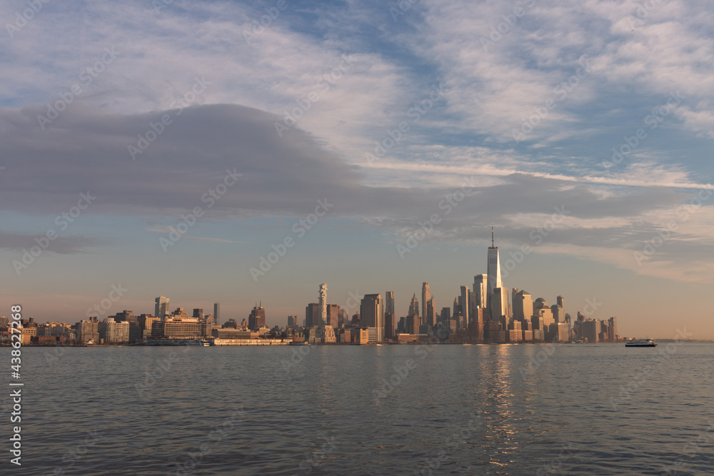Wide Lower Manhattan Skyline along the Hudson River during a Warm Sunset in New York City Wide Lower Manhattan Skyline along the Hudson River during a Warm Sunset in New York City