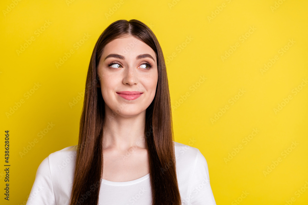 Portrait of attractive cheerful minded girl looking aside thinking copy empty space isolated over bright yellow color background Portrait of attractive cheerful minded girl looking aside thinking copy empty space isolated over bright yellow color background