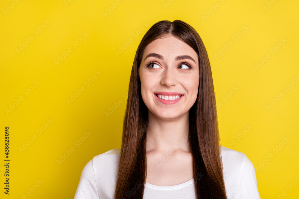 Photo of young cheerful woman happy positive smile curious dream look empty space isolated over yellow color background Photo of young cheerful woman happy positive smile curious dream look empty space isolated over yellow color background