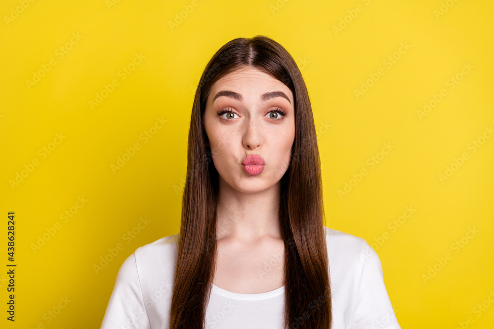 Photo of young lovely girl pouted lips send air kiss flirty romantic love isolated over yellow color background Photo of young lovely girl pouted lips send air kiss flirty romantic love isolated over yellow color background