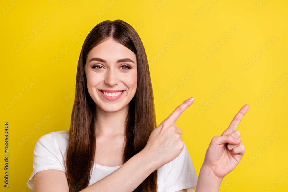 Photo portrait of woman showing copyspace advising happy smiling isolated bright yellow color background Photo portrait of woman showing copyspace advising happy smiling isolated bright yellow color background