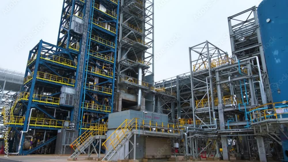 Tower for the distillation of oil and gasoline. Epic top-down footage showing the height of the column. Steel pipelines at an oil refinery. Tower for the distillation of oil and gasoline. Epic top-down footage showing the height of the column. Steel pipelines at an oil refinery.