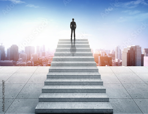 Vision concept. Successful businessman standing on staircase and looking over city © Retouch man