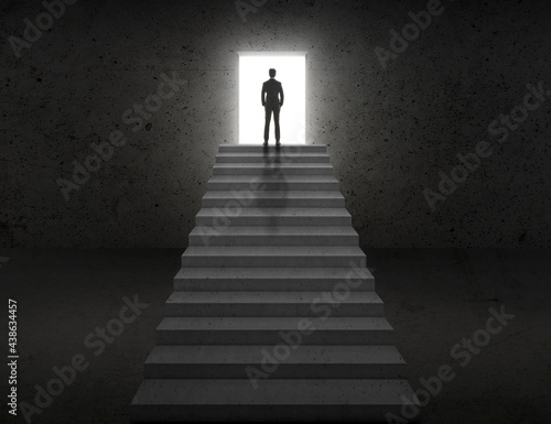 Vision concept. Successful businessman standing on staircase