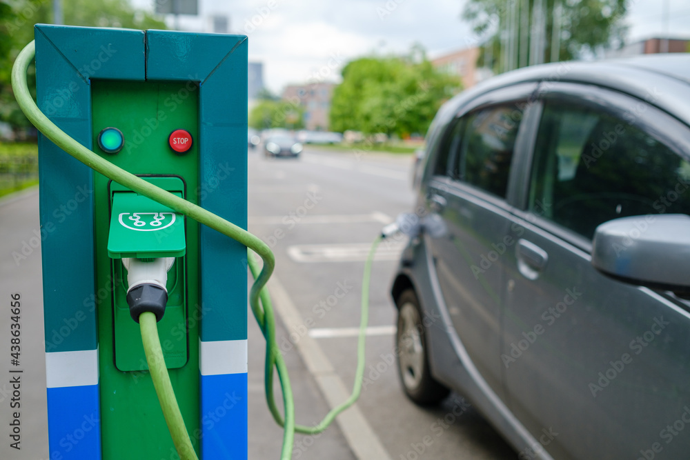 Charging station and electric vehicle on parking lot Charging station and electric vehicle on parking lot