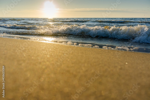 Sunset over the sea. Red and yellow sky in the rays of the sunset. Reflection of sunlight in the sea waves.