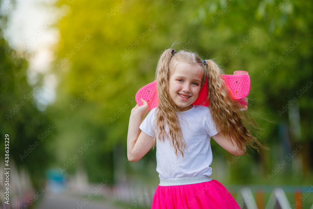 little girl skateboarding in the park in summer little girl skateboarding in the park in summer