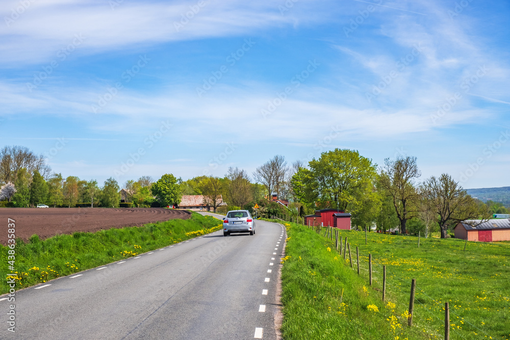 Car driving on a road in the countryside Car driving on a road in the countryside