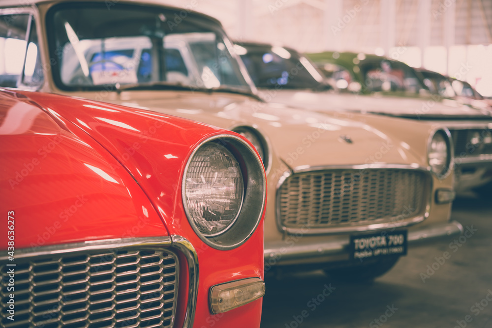 Close up round headlights of red vintage classic car. Transportation