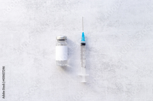 Covid vaccine in bottles with syringe. Top view
