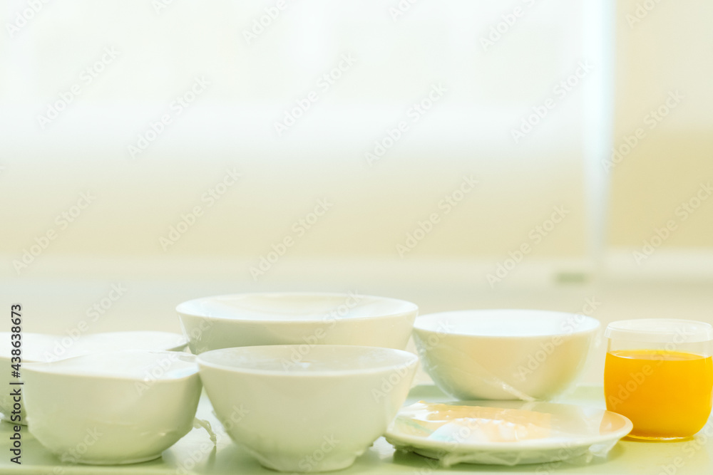 Food tray on the table in a room of a hospital. Patient and hospital concept. Copy space. 