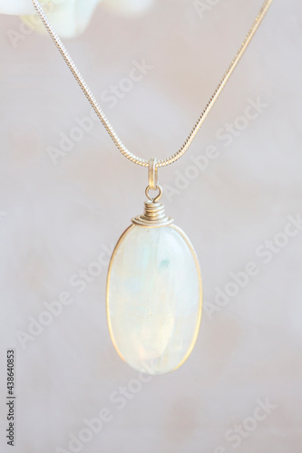 Mineral moon stone sterling silver simple pendant on neutral background