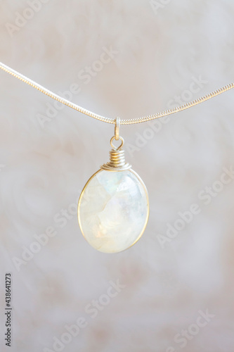 Mineral moon stone sterling silver simple pendant on neutral background