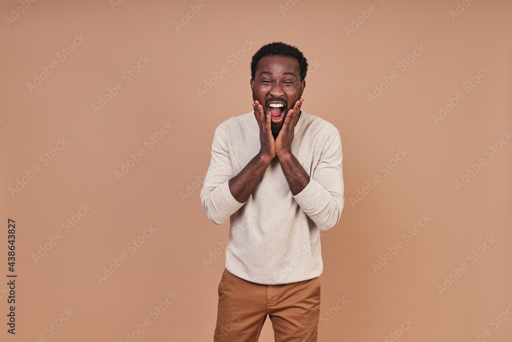 Handsome young African man in casual closing smiling and looking at camera