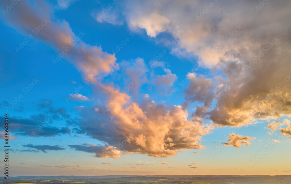 Colorful blue sky background, pink-orange dramatic clouds, aerial photography, far horizon. Ideal for sky replacement postproces.