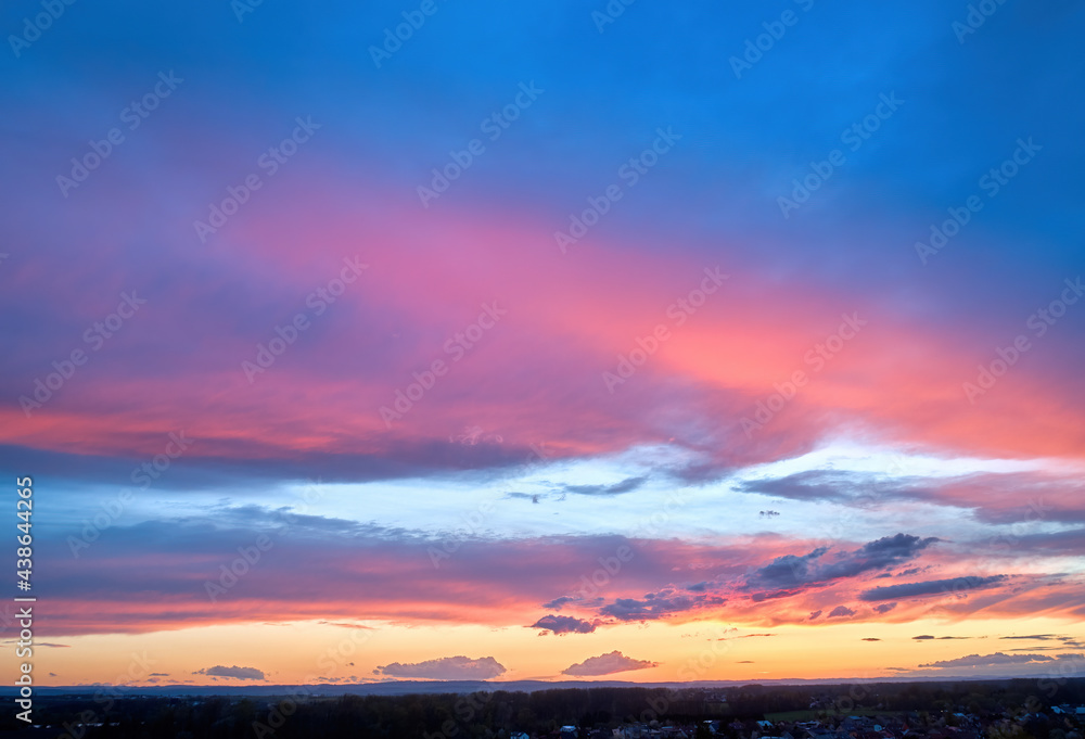 Colorful blue sky background, pink-orange dramatic clouds, aerial photography, far horizon. Ideal for sky replacement postproces.
