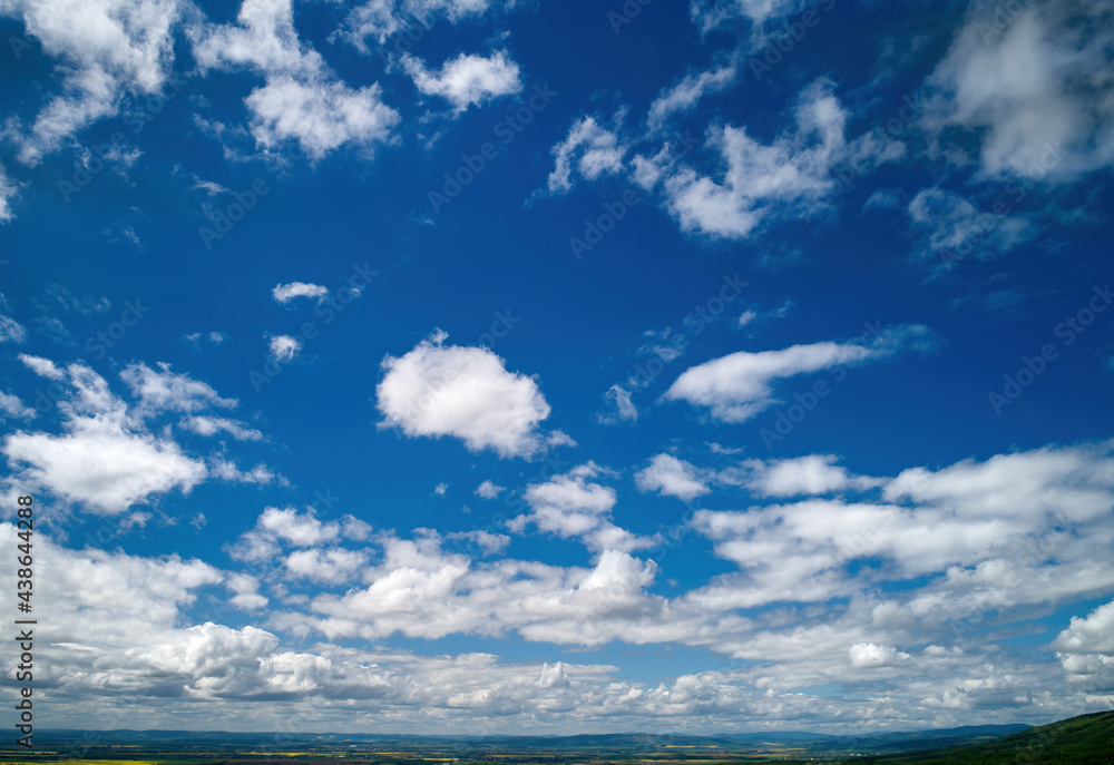 Colorful blue sky background, white tiny clouds, aerial photography, far horizon. Ideal for sky replacement postproces.