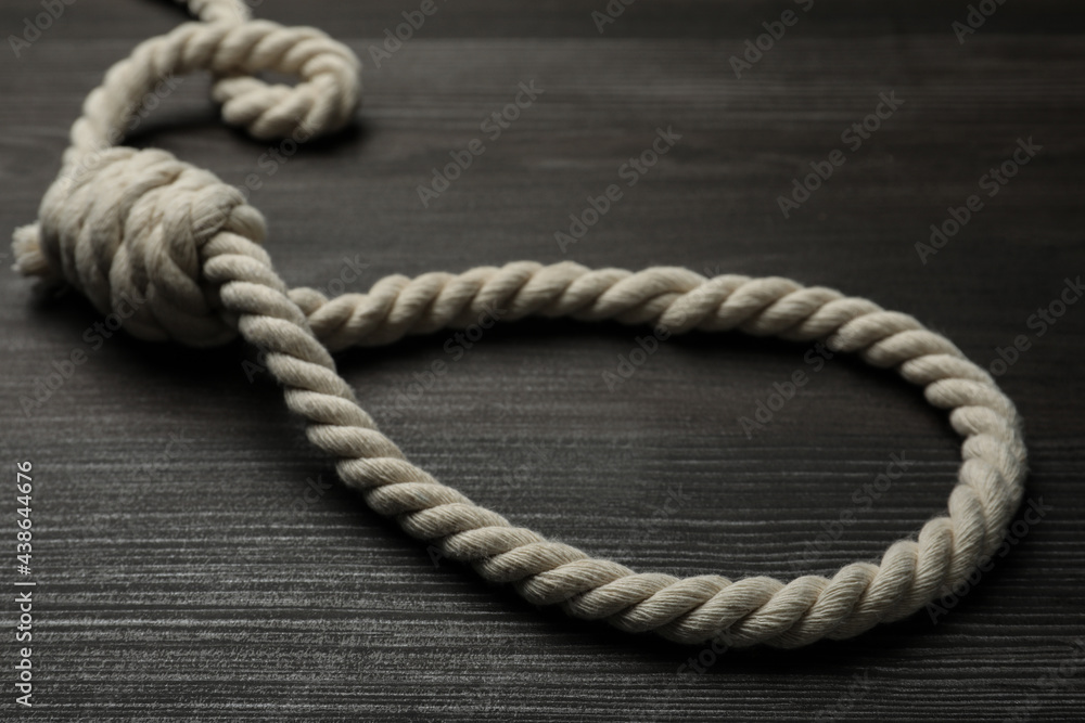 Obraz premium Rope noose on dark wooden table, closeup
