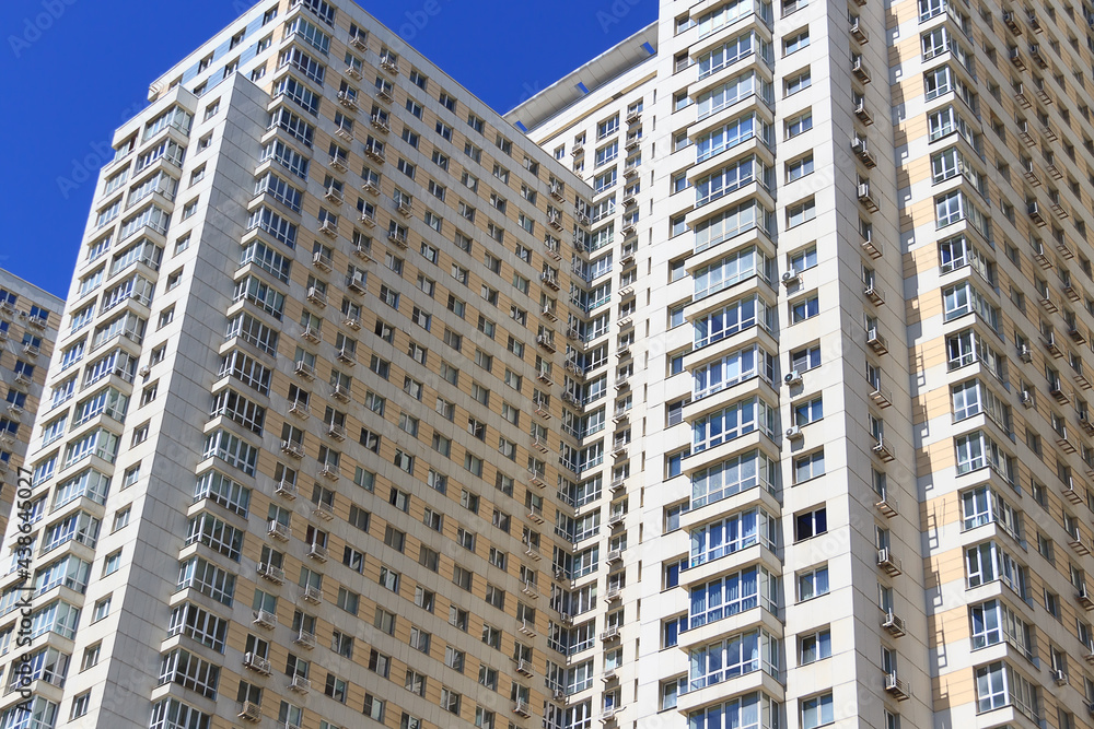 Facade of a multi-storey modern building. Typical city development. Facade of a multi-storey modern building. Typical city development.